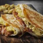 The Folded Breakfast Tortilla with Scrambled Eggs, Bacon, Tomato and Cheese