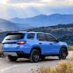 Electric Blue Honda Pilot on a mountain road