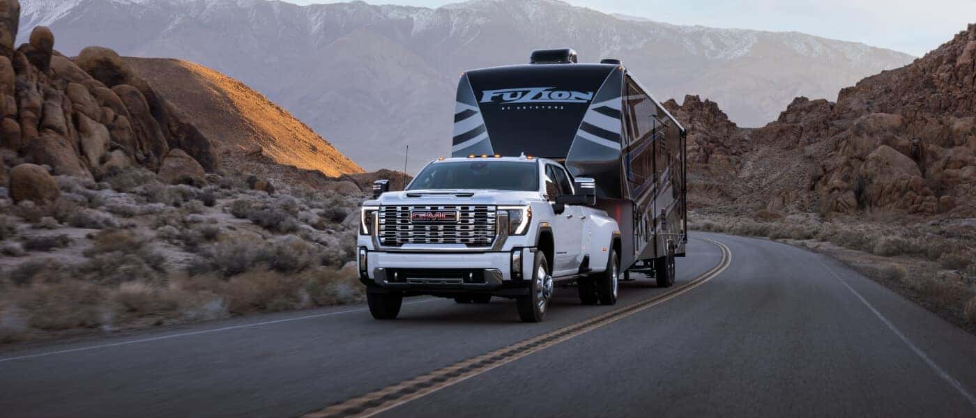 2025 GMC Sierra 3500 Exterior Pulling Camper In Desert