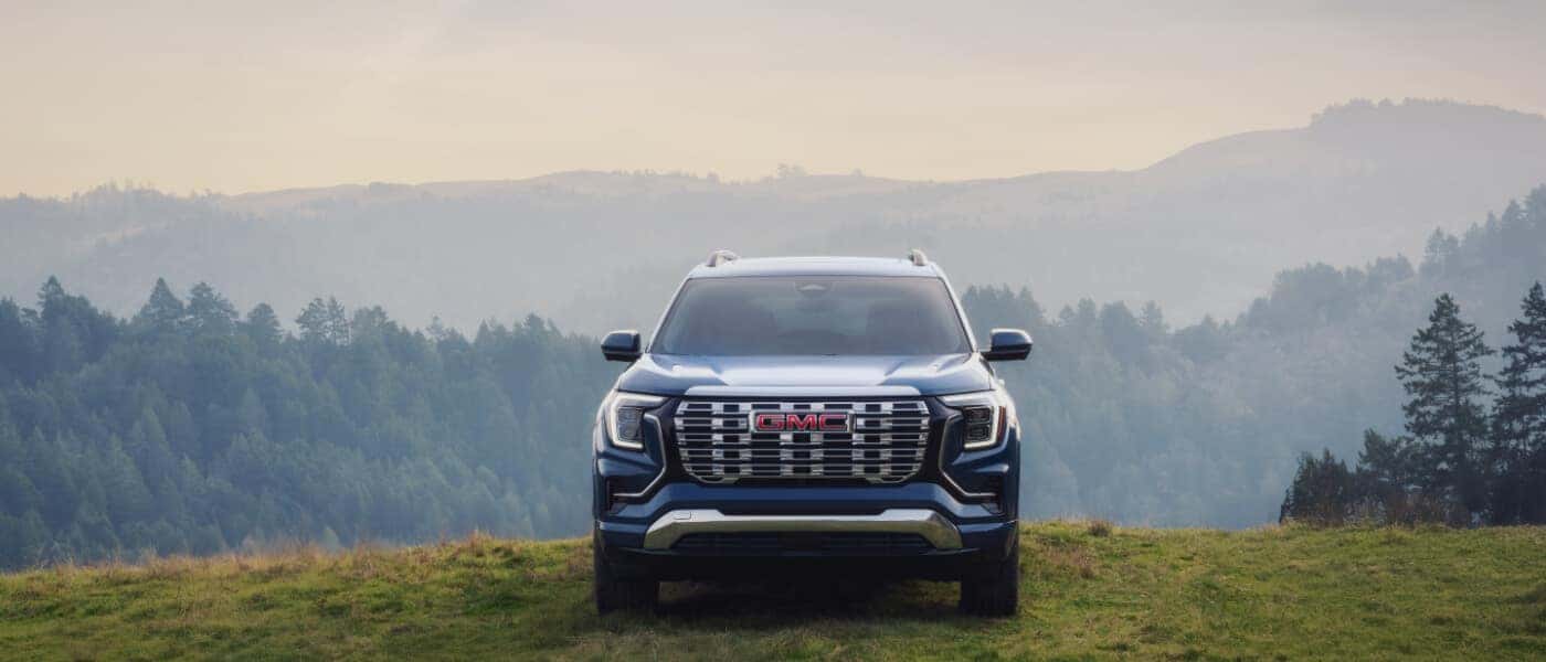 2026 GMC Terrain Exterior Parked In Grass With Forest Hills