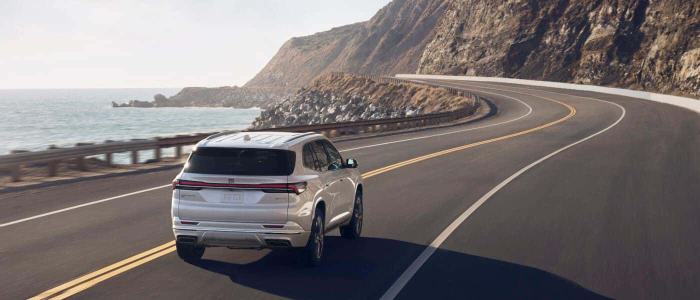 2027 Buick Enclave driving away by water