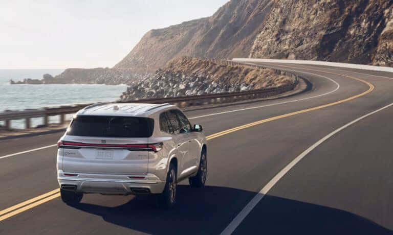 2027 Buick Enclave driving away by water