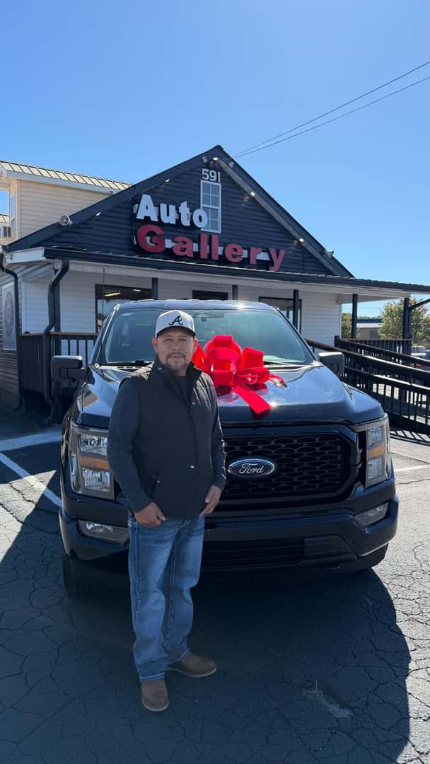 Customer beside a Ford pickup at Auto Gallery