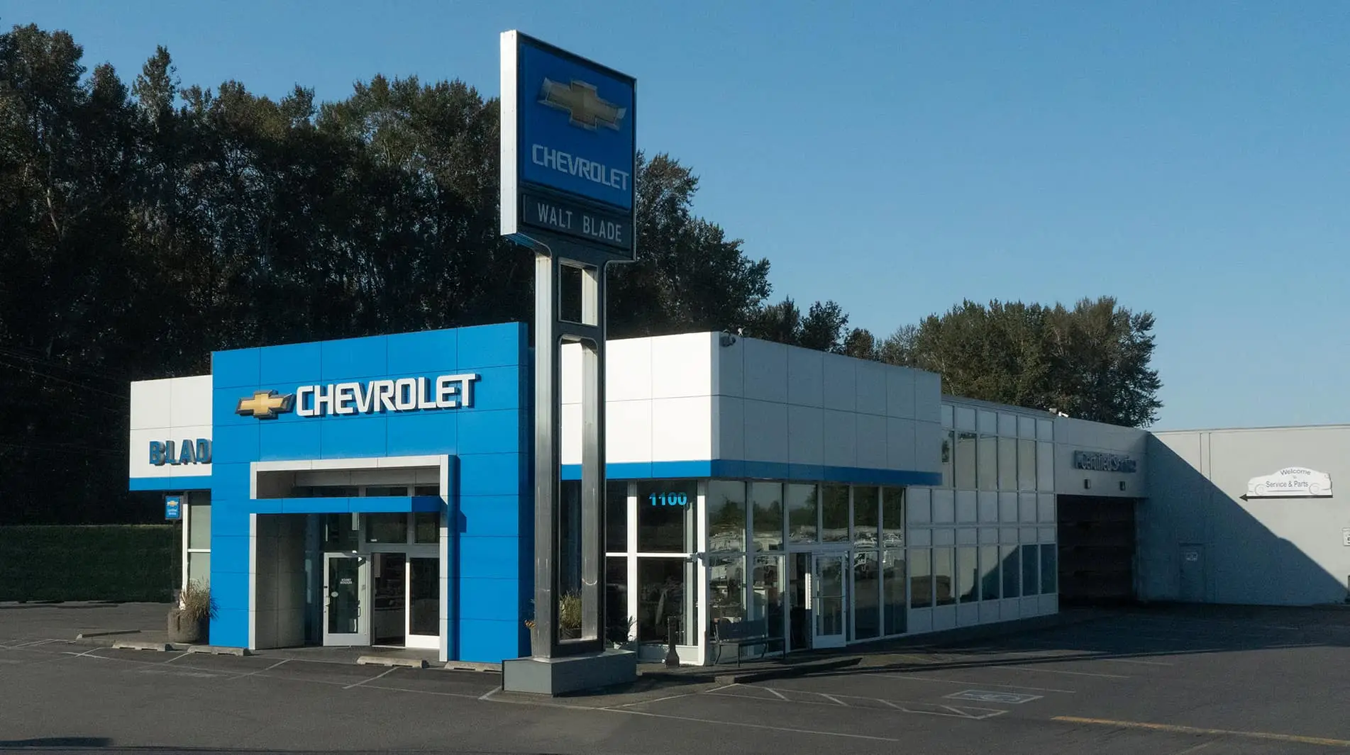 An exterior shot of a Chevrolet dealership during day.