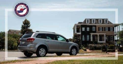 Dodge SUV parked in front of home