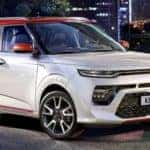 White Kia Soul in Front of City Lights