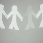 paper cutout people holding hands