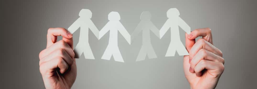 paper cutout people holding hands