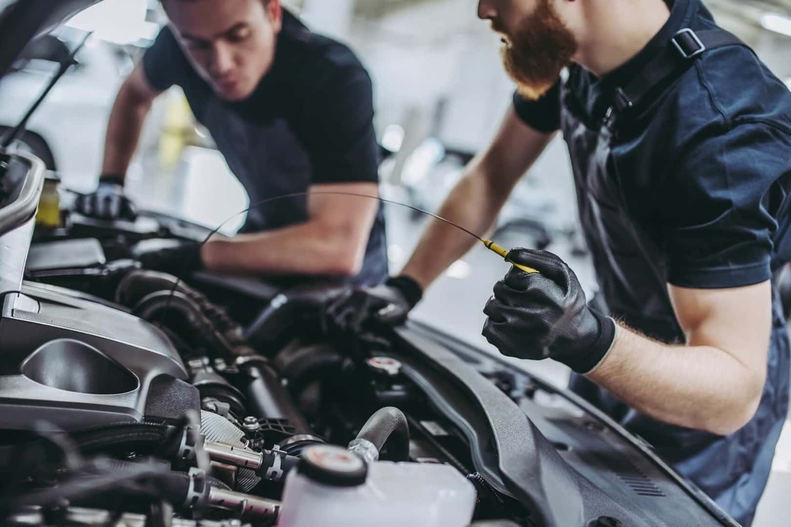 Two Men Looking Under Hood of Car