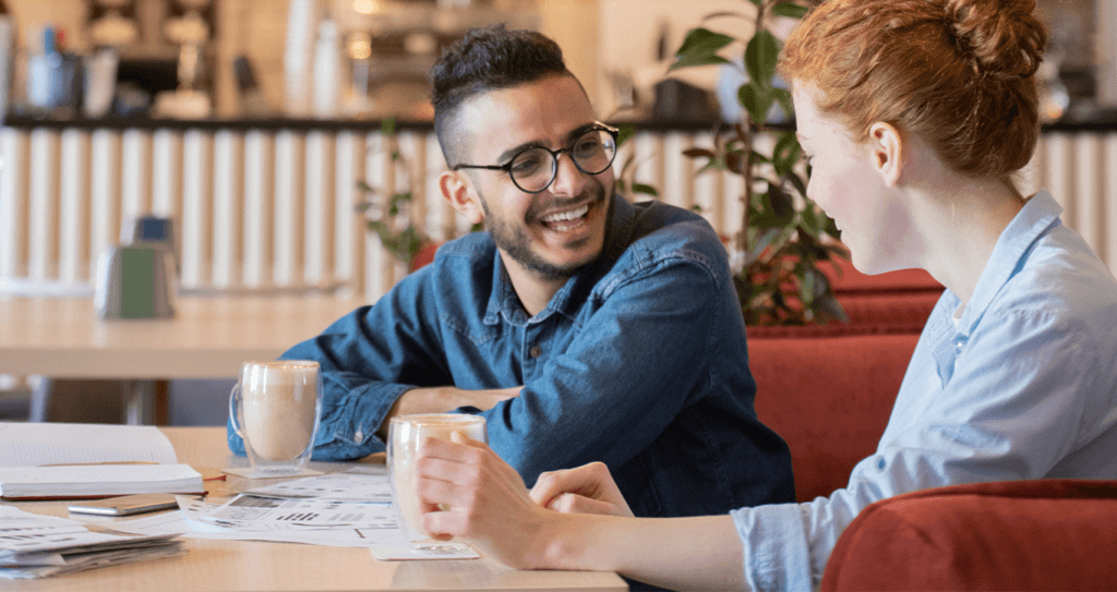 Volvo Dealer near Latrobe | Man and woman talking to each other inside of a cafe while drinking coffee