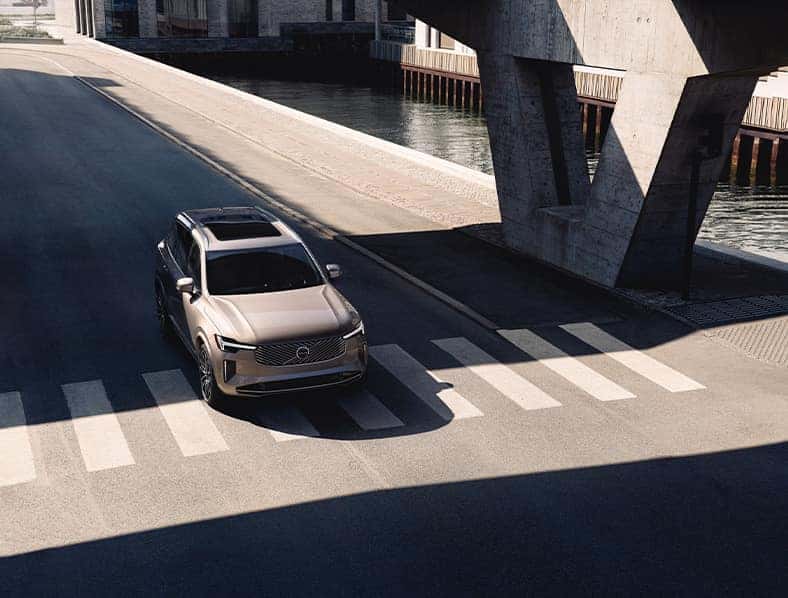 2025 Volvo XC90 | 2025 Volvo XC90 driving down the street under a bridge