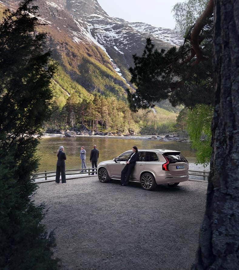 2025 Volvo XC90 | Group of people standing outside by a national parked with their parked 2025 Volvo XC90