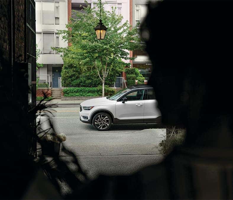 2025 Volvo XC40 | Side profile of a 2025 Volvo XC40 driving by the street