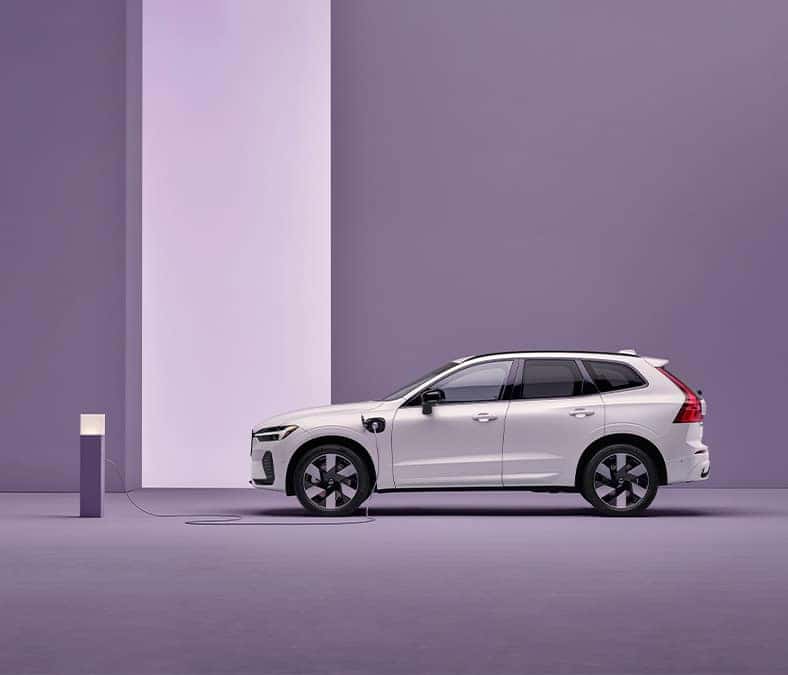 2025 Volvo XC60  | White 2025 Volvo XC60 charging with plug in charger