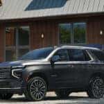 2025 Chevrolet Tahoe parked in front of a cabin