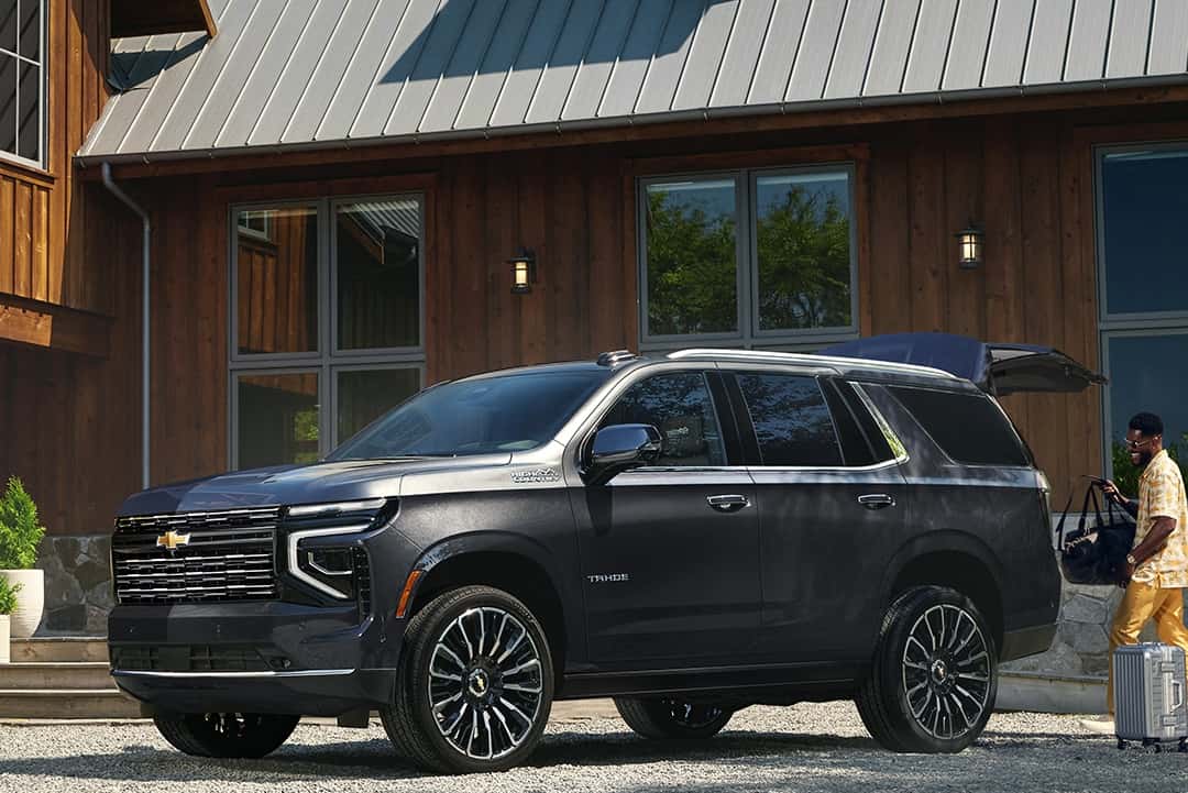 2025 Chevrolet Tahoe parked in front of a cabin