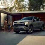 2025-Chevy-Silverado-1500-parked-in-a-driveway-while-a-couple-walks-beside-it