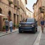 Chevrolet SUV driving safely through Old Town Auburn CA with pedestrians