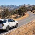 2026 Chevrolet Tahoe Z71 driving Foresthill Road in Auburn, California, Sierra Nevada foothills canyon in background