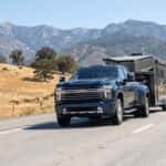 Chevrolet truck on I-80 summer climb toward Donner Summit from Auburn CA with dashboard temperature gauge visible
