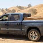 Used Chevrolet Silverado 1500 crew cab loaded with lumber on a Sierra Nevada foothills road near Auburn, CA in summer