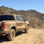 2026 Chevrolet Colorado Trail Boss with tailgate open and hiking gear loaded at a trailhead in the Auburn State Recreation Area foothills