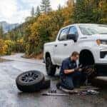 2026 Chevrolet Silverado 1500 on a wet Sierra foothills road near Auburn CA with front wheel removed for brake inspection