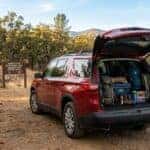 2027 Chevrolet Traverse with liftgate open and organized trail gear at an Auburn SRA trailhead in fall