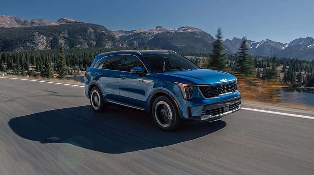 blue 2025 Kia Sorento Hybrid driving on road