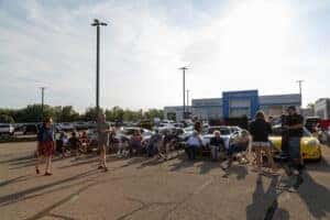 Corvette Lineup and People Gathered at Car Show