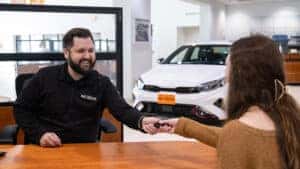 Sales Consultant with Client Handing Off Keys