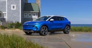 Blue Chevy Equinox EV in a driveaway 