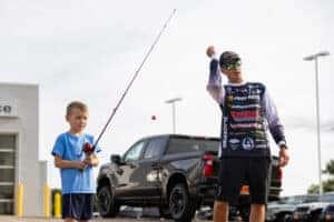 Glenn Walker and a child with a fishing pole 