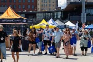 People walking next to Jeff Belzer tent at Grillfest 