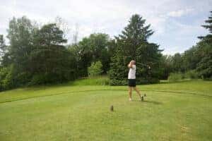 Man swinging golf club 