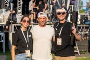 Two people and Jeff Belzer smiling for a picture
