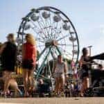 People walking in front of ferris wheel