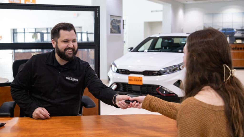 Sales Consultant with Client Handing Off Keys