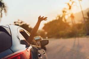Person in car with hand out of the window