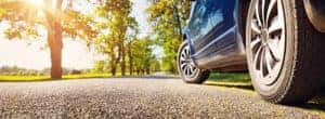 view of tires on pavement on sunny day