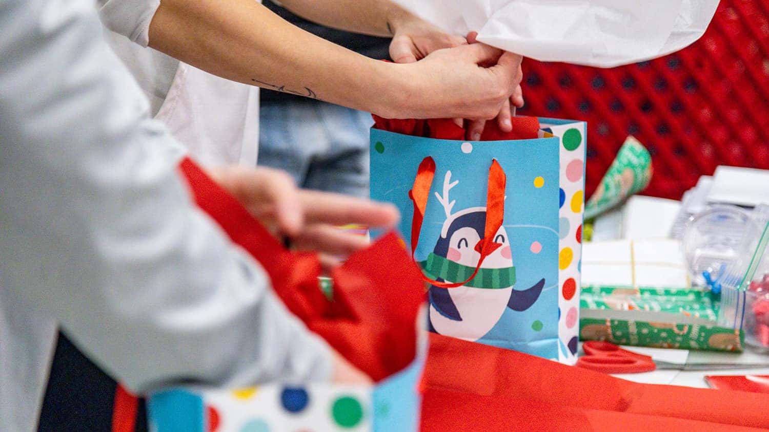 putting presents into gift bags at Shop with a Hero event