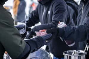serving barbeque at Charlie's on Prior Beer & BBQ Fest