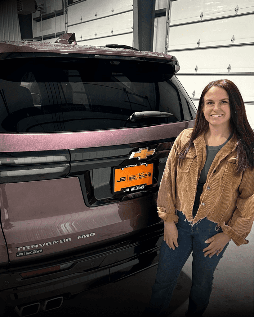 woman standing in front of the tailgate on the 2025 Chevrolet Traverse