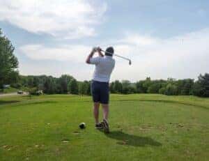 golfer swinging at B-52 x LHA golf tournament