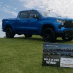 Chevrolet Silverado with sign that says "win this vehicle"