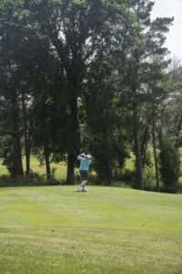 golfer swinging at Wilds Golf Club