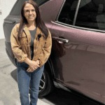 Allye standing in-front of a Chevrolet vehicle