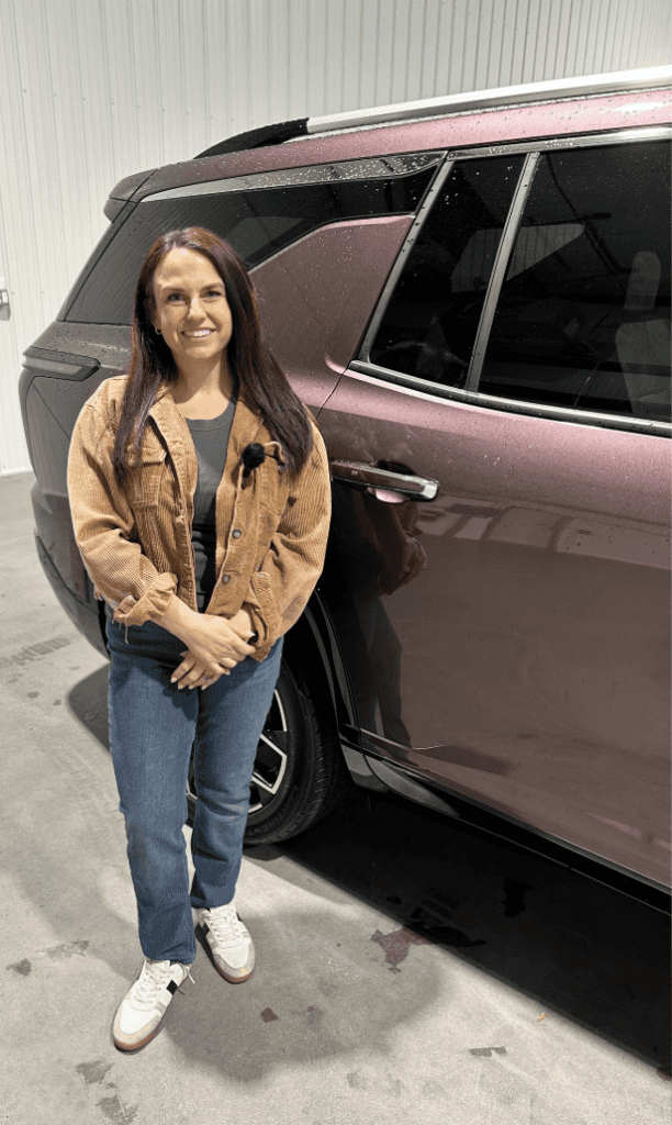 Allye standing in-front of a Chevrolet vehicle