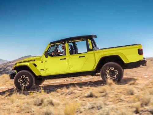 2023 Jeep Gladiator driving in grassy field