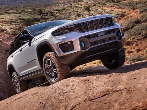 2023 Jeep Grand Cherokee 4xe driving on a rocky path